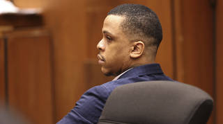Defendant Eric Holder listens during opening statements in his murder trial