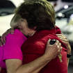 Church members console each other after the shooting