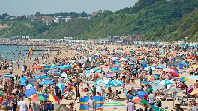 People relax in the hot weather on Bournemouth beach in Dorset
