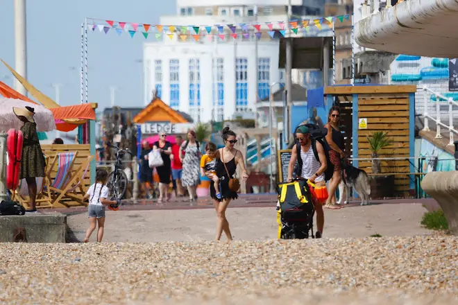 A family of beach-goers arrive to enjoy the sun in Hastings