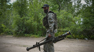 A Ukrainian soldier carries a US-supplied Stinger as he goes along the road in Ukraine’s eastern Donetsk region