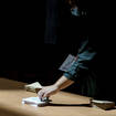 A voter picks up ballots before voting in the second round of the French parliamentary election in Lyon, central France