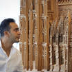 Fadel Alkhudr from Syria poses near the south part of his wooden model of Cologne Cathedral on display at the Domforum in Cologne, Germany