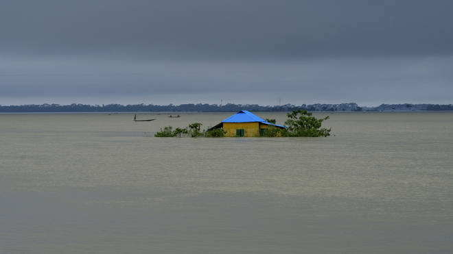 A house stands surrounded by floodwaters in Sylhet, Bangladesh, on Monday, June 20 2022