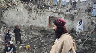 Afghans look at destruction caused by an earthquake in the province of Paktika, eastern Afghanistan