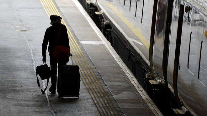 A passenger walks along a platform at Waverley Station in Edinburgh