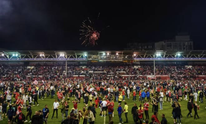 Nottingham Forest fans celebrate on the pitch after they reach the play off final