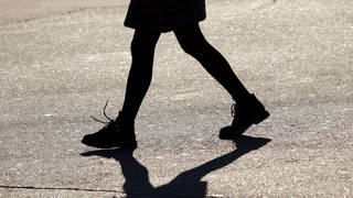Silhouette and shadow of girl walking down the street
