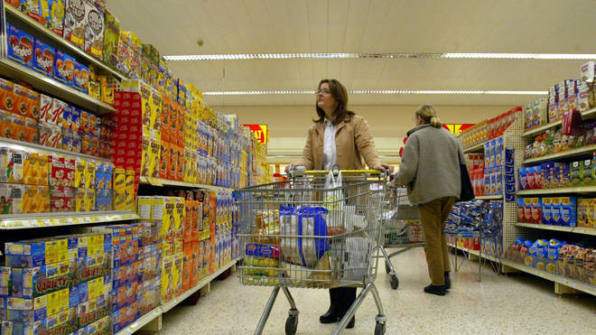 A woman with a shopping trolley in a supermarket