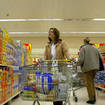 A woman with a shopping trolley in a supermarket