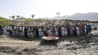 Afghans pray for relatives killed in the earthquake at a burial site in Gayan village, Paktika province