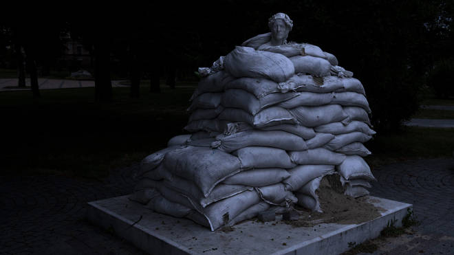 The sculpture of prominent Italian poet Dante Alighieri is protected by sandbags, on Vladimir’s Hill in Kyiv, Ukraine