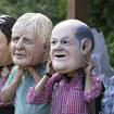 Activists from Oxfam wear giant heads depicting G7 leaders during a demonstration in Munich, Germany