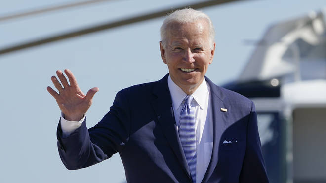 President Joe Biden waves to the media as he walks to board Air Force One at Andrews Air Force Base, Maryland