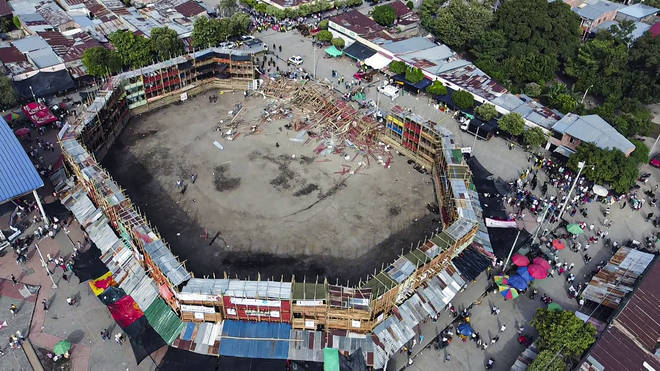 At least four people were killed and another 30 seriously injured when a full three-story section of wooden stands filled with spectators collapsed, throwing dozens of people to the ground.