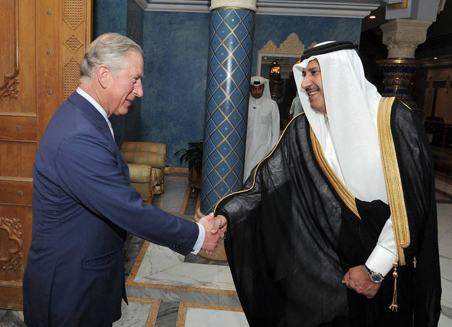 Prince Charles shakes hands with the then Qatari Prime Minister Sheikh Hamad Bin Jassim al Thani, at his residence outside Doha, Qatar in 2013.