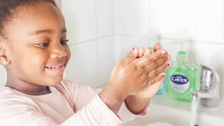 A girl washing her hands