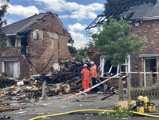 Investigators working at the scene of the house blast today