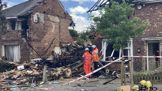 Investigators working at the scene of the house blast today