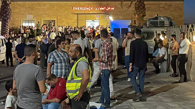 People gather outside a hospital following a toxic gas explosion in Jordan