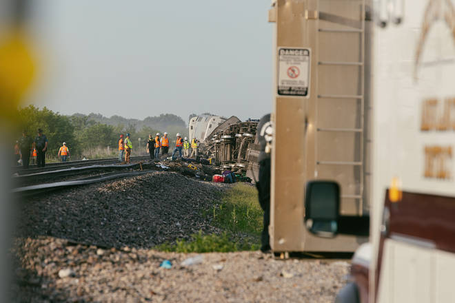 Police and railroad workers work the scene where an Amtrak train derailed on June 27, 2022 in Mendon, Missouri.