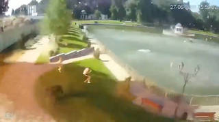 The clip shows panicked civilians in a nearby park