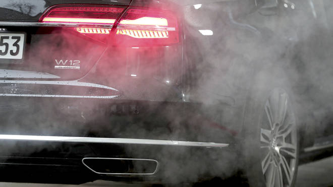 A car surrounded by exhaust fumes