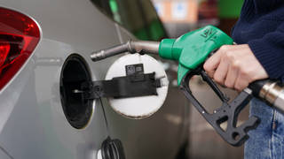 A motorist fills up with petrol