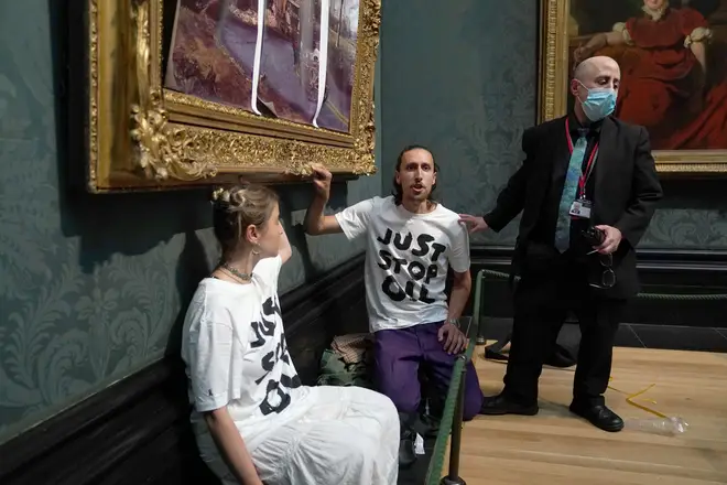 The protesters placed a hand on the frame of the painting and kneeled beneath it before loudly stating their concerns as visitors were ushered out by security staff.  	