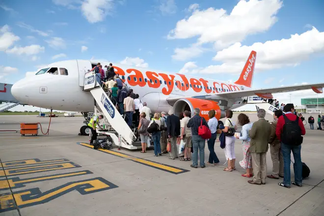Passengers are pictured boarding an EasyJet plane