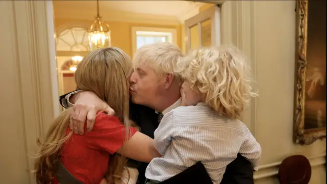 Mr Johnson embraces his family after his resignation speech