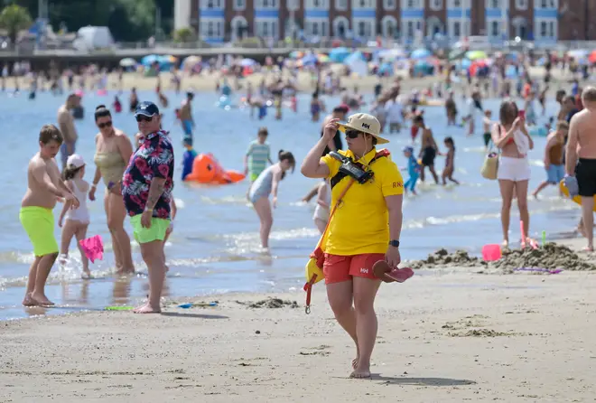 A lifeguard patrols at the beach in Weymouth.