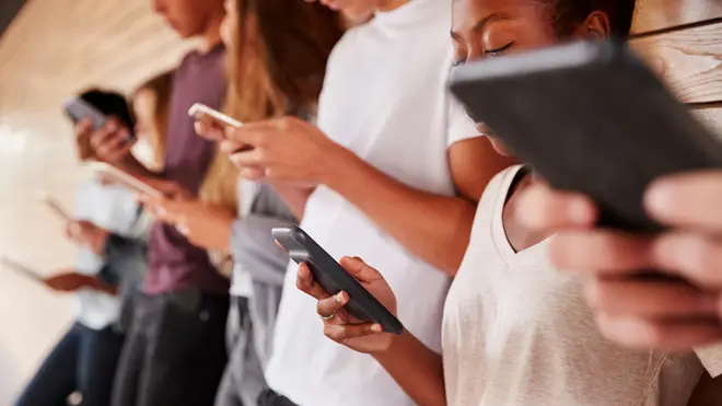 Teenage students using digital devices