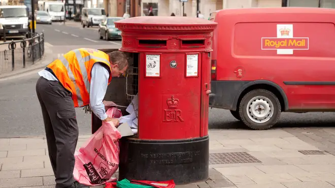 Royal Mail worker emptying post box