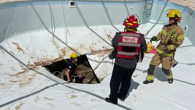 A man has died after being swallowed by swimming pool sinkhole