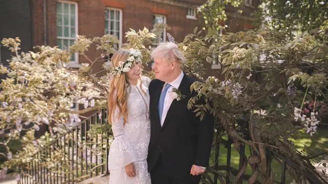 Boris Johnson poses with his wife Carrie Johnson in the garden of 10 Downing Street following their wedding at Westminster Cathedral last year