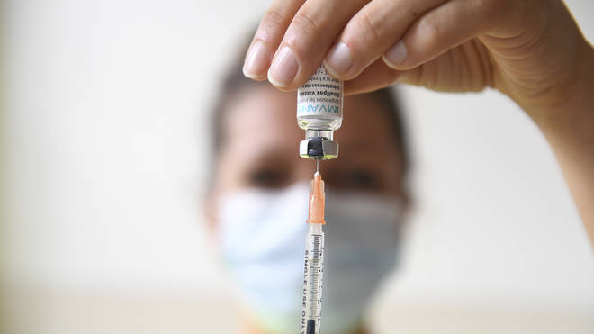 FILE – A health professional prepares a dose of a Monkeypox vaccine