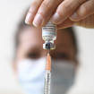 FILE – A health professional prepares a dose of a Monkeypox vaccine