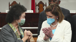 Nancy Pelosi (right) reacts to Chen Chu