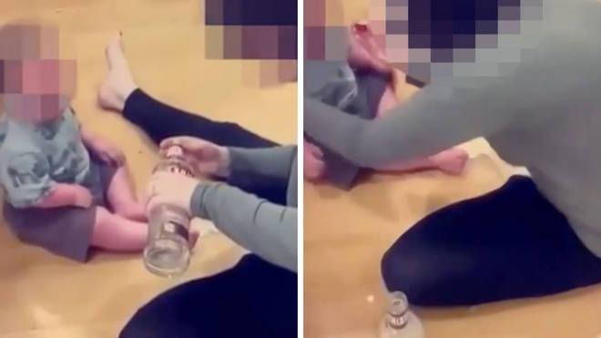 A baby has been seen drinking clear liquid from a vodka glass