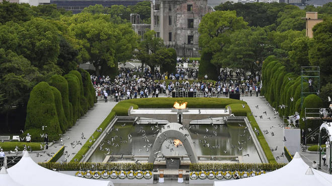 Doves fly over the cenotaph dedicated to the victims of the atomic bombing during the ceremony marking the 77th anniversary of the world’s first atomic bombing, at the Hiroshima Peace Memorial Park in Hiroshima, western Japan
