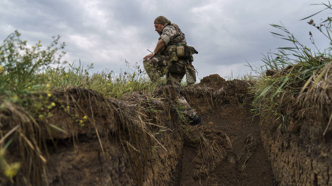 Sgt Maj Artur Shevtsov with the Dnipro-1 regiment exits a bunker at the unit’s position near Sloviansk, Donetsk region, eastern Ukraine