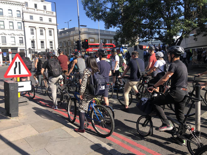 Grant Shapps said a 'selfish' minority of cyclists think they are immune to red lights. File image shows cyclists waiting at red lights in London