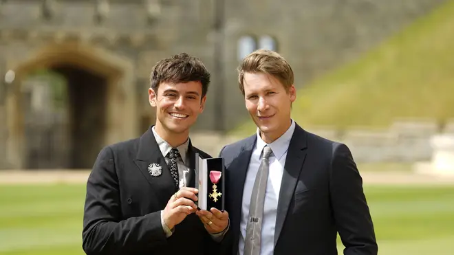 Tom Daley, and his husband Dustin Lance Black, with his OBE