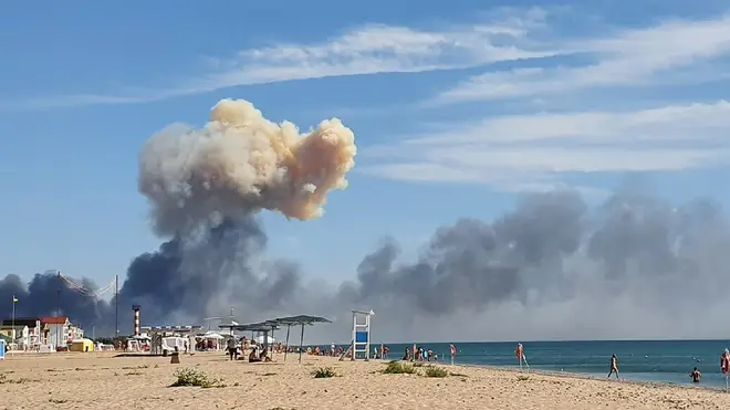Rising smoke can be seen from the beach at Saky after explosions were heard from the direction of a Russian military airbase near Novofedorivka, Crimea