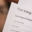 Woman looks at energy bill