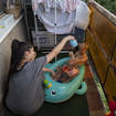 Krisztina plays with her children on their balcony in Budapest, Hungary