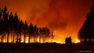 Firefighters tackling a blaze near Saint-Magne, south of Bordeaux, southwestern France