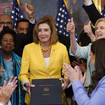 House Speaker Nancy Pelosi of Calif., surrounded by House Democrats, poses after signing the Inflation Reduction Act of 2022 during a bill enrollment ceremony on Capitol Hill in Washington, Friday, Aug. 12, 2022