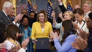 House Speaker Nancy Pelosi of Calif., surrounded by House Democrats, poses after signing the Inflation Reduction Act of 2022 during a bill enrollment ceremony on Capitol Hill in Washington, Friday, Aug. 12, 2022